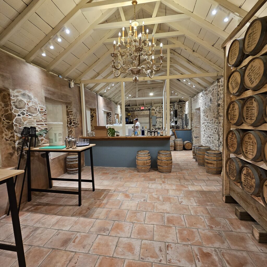 inside the distillery with rum barrels